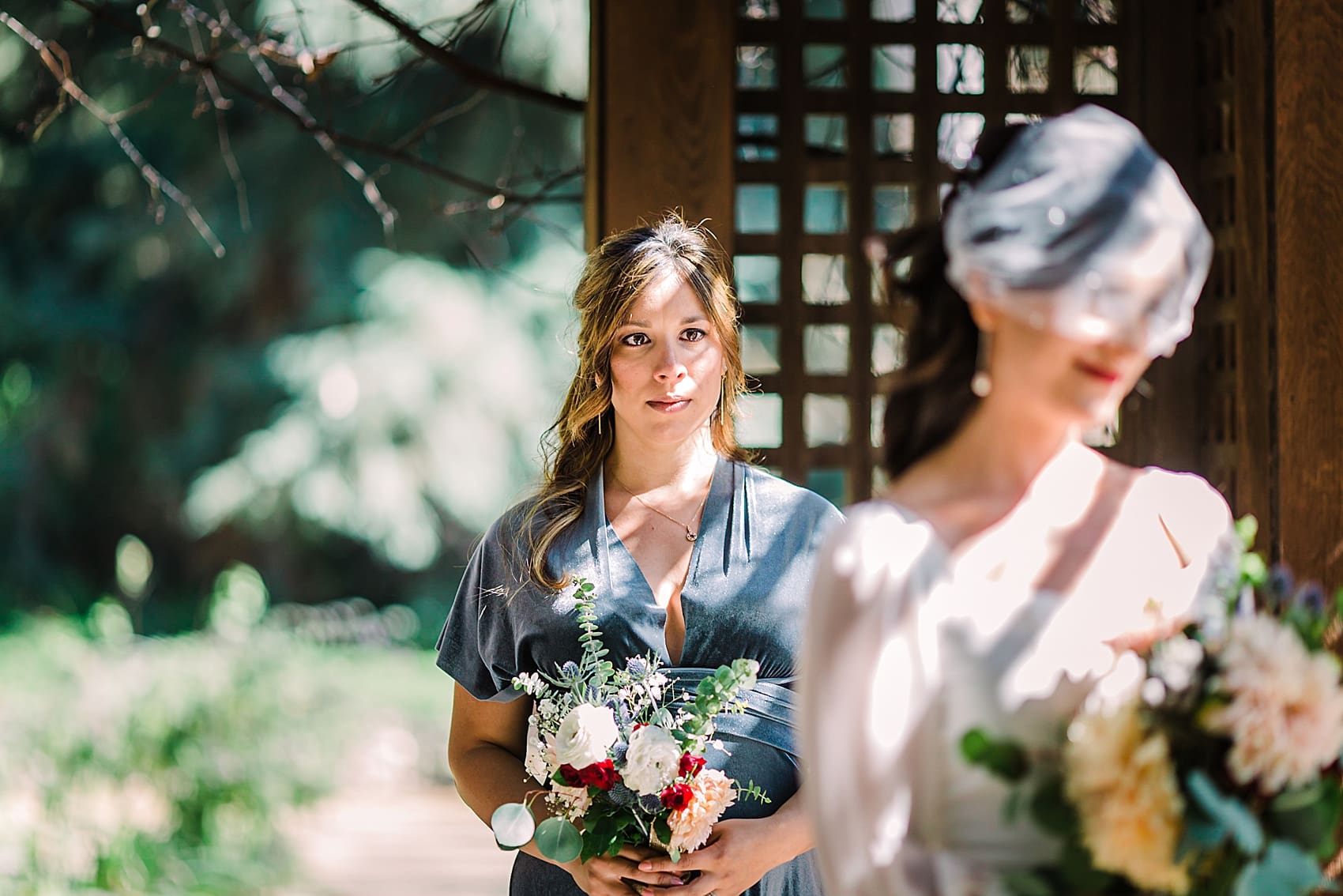 Bridesmaid crying in botanical garden wedding