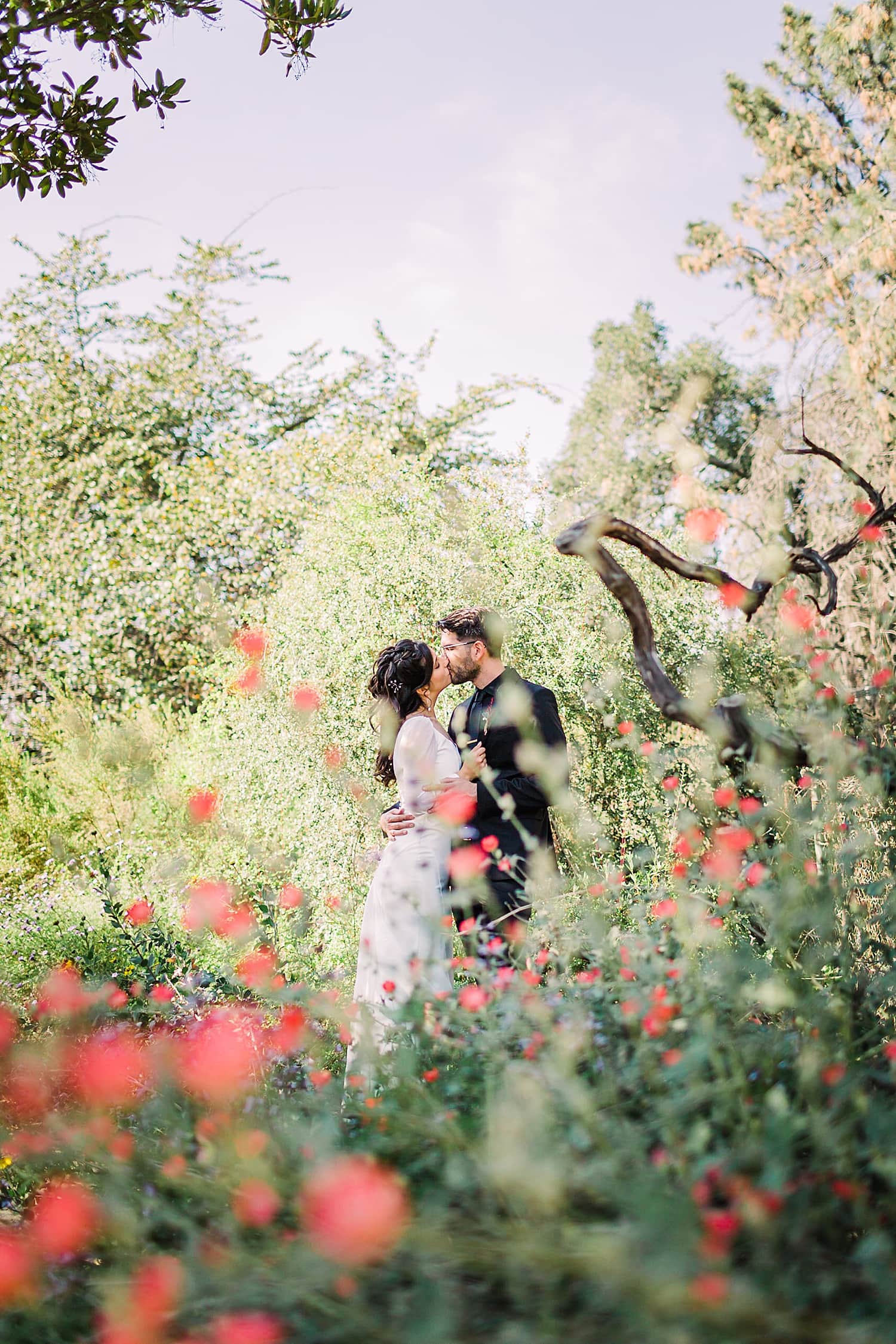 Bride and Groom in California poppies in botanical garden