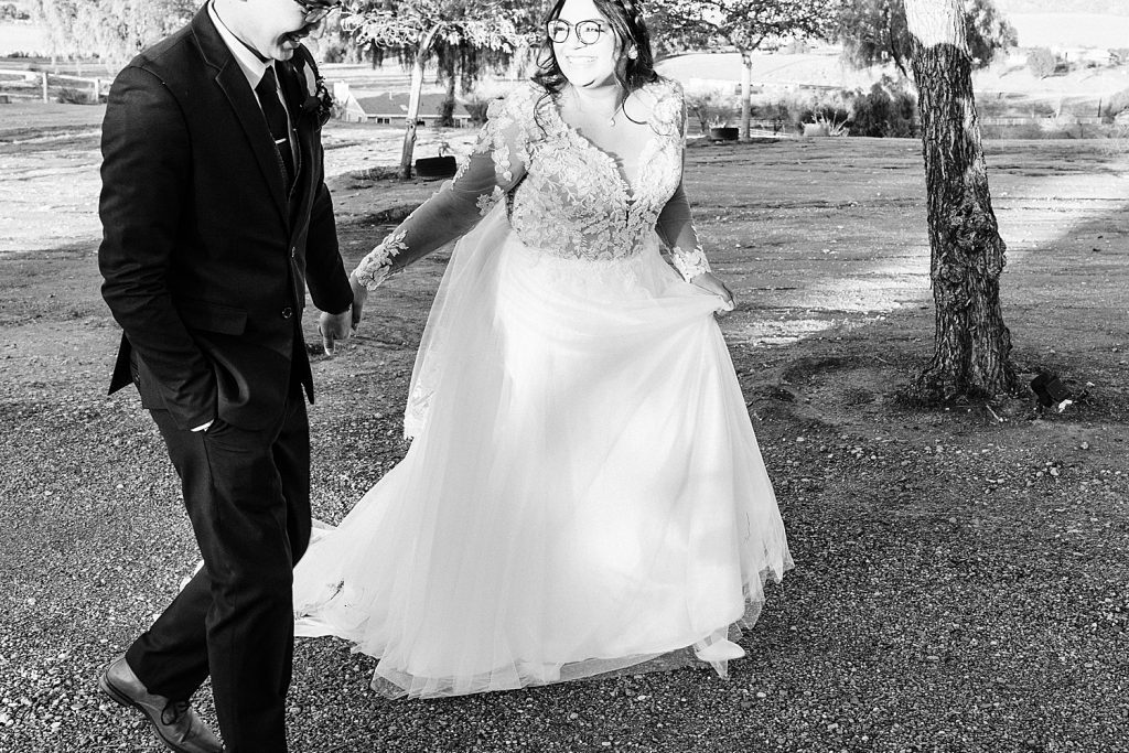 Bride and groom running Nuevo ranch wedding