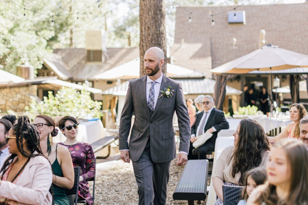 groom walking up aisle