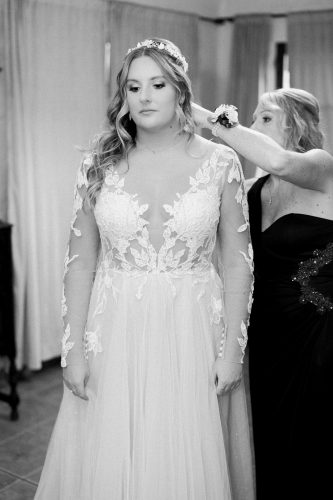 Bride putting on dress hidden oaks retreat 