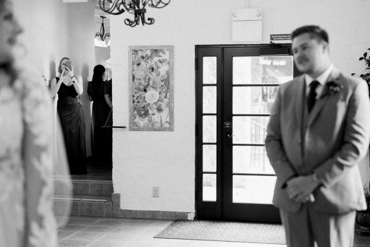 mother of the bride watching first look at hidden oaks retreat center