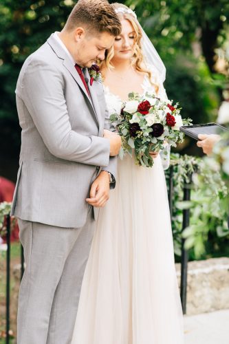 Bride and groom praying at hidden oaks retreat