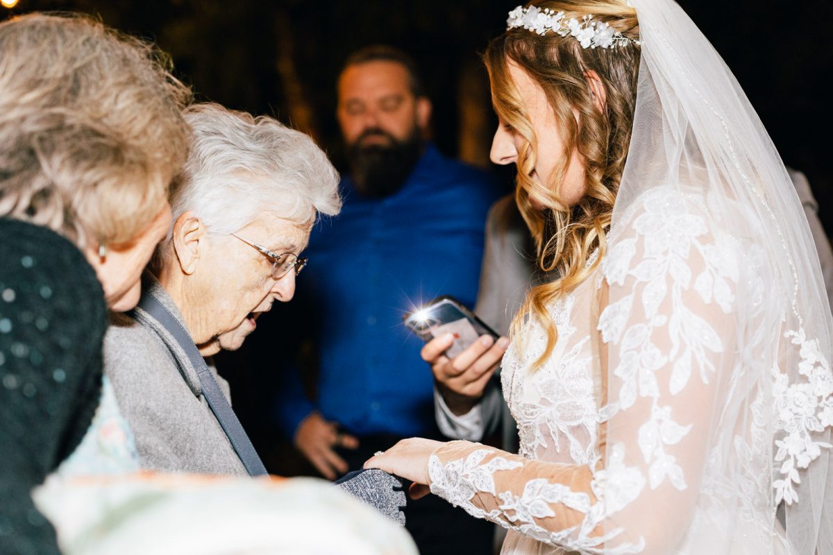 grandma looking at the bride's ring