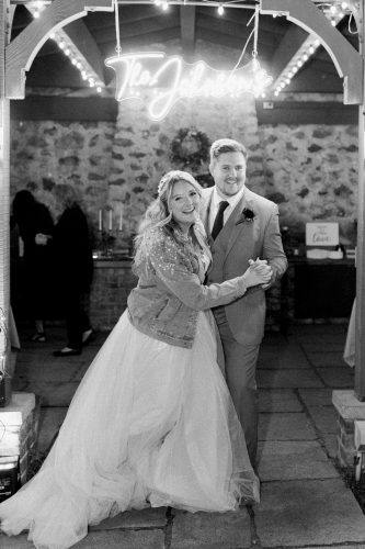 bride and groom and neon sign at wedding