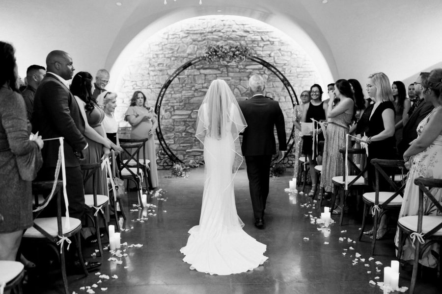 bride walking up the aisle in Vienza cave at Europa Village Wineries