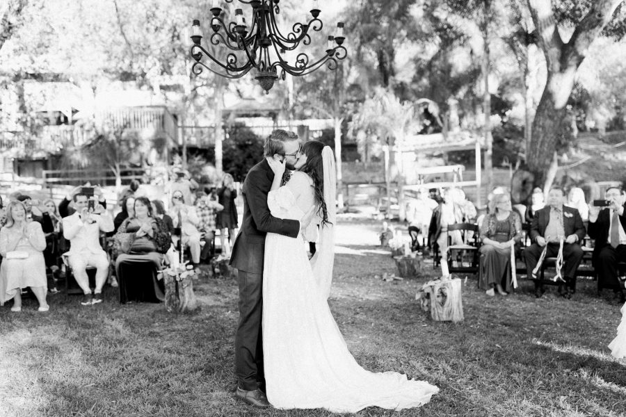 first kiss with guests in the background