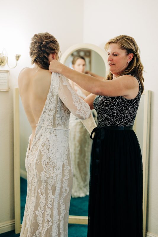 bride's mom helping her get ready