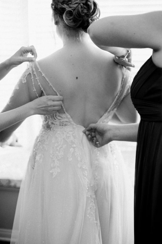 bride getting in dress