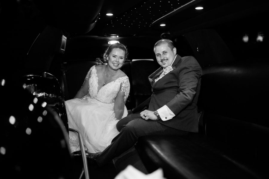 bride and groom in limo