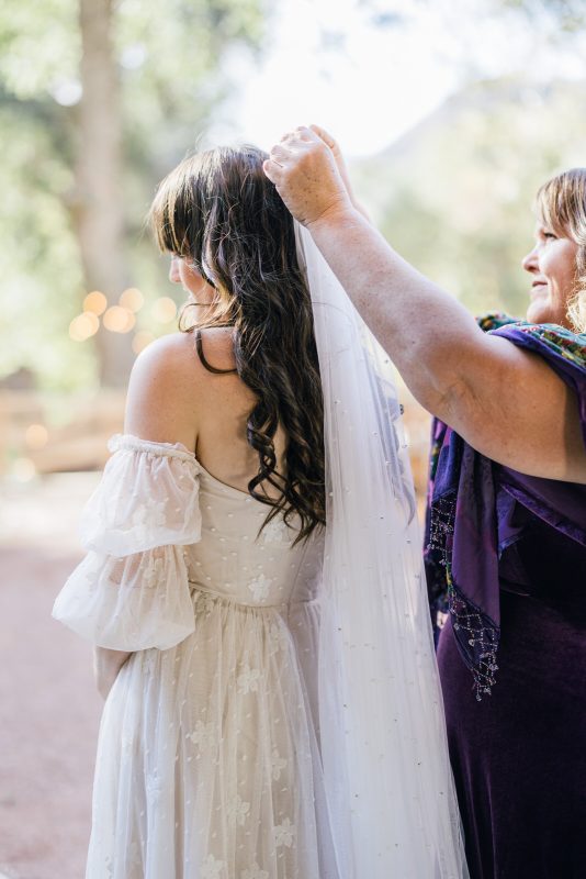 bride putting on veil