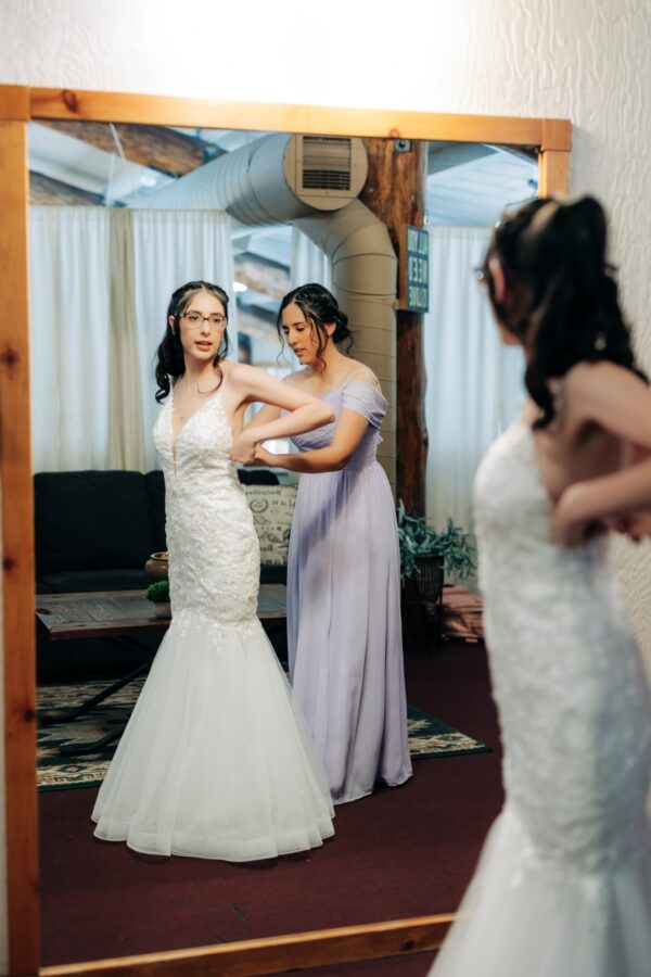 bride getting her dress on Lake Gregory wedding