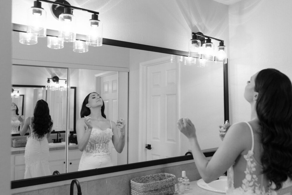 bride putting on perfume for stone brewing garden and bistro wedding