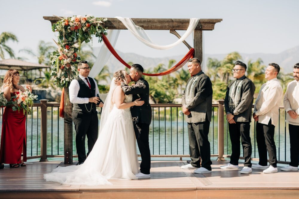 First kiss at the pond at Casey orchard Redlands wedding