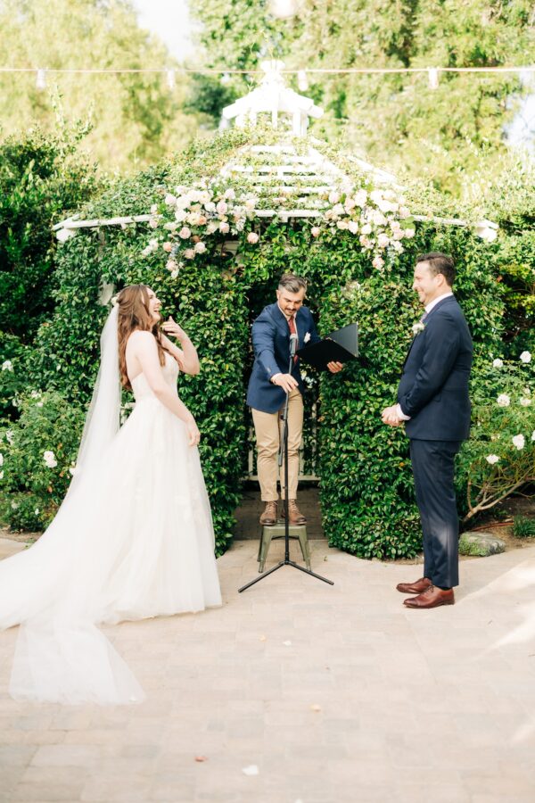 Short officiant standing on step for ceremony